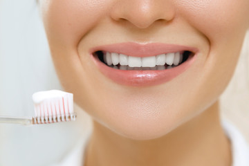 Woman is cleaning teeth