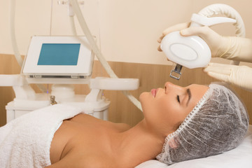 Beautiful woman in beauty salon during rejuvenation procedure