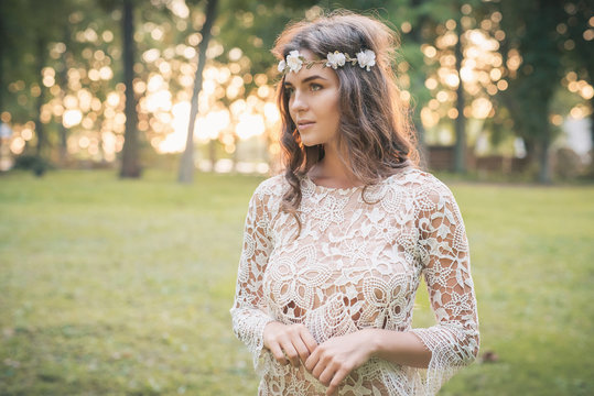 Beautiful woman wearing lace dress and circlet of flowers