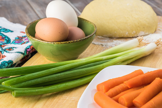 Ingredients for pie bites with egg and vegetable filling.