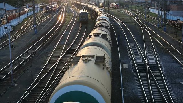 Freight train passing by at sunset