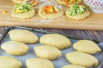 Unbaked pie bites with egg and vegetable filling.