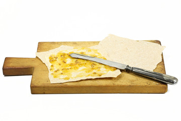 Norwegian Flatbrød with cloudberry jam isolated on white background