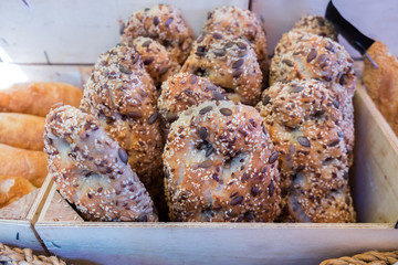 Fresh brown buns with sesame and sunflower seeds  for sale at local farmers market