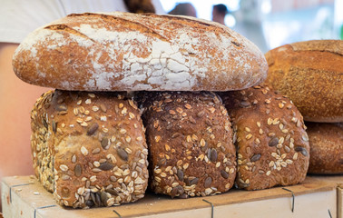 Fresh brown bread with sesame and sunflower seeds for sale at local farmers market