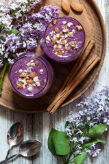 Obraz na płótnie Canvas Blueberry oatmeal smoothies with almond, flat lay