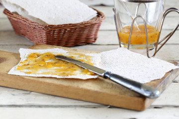 Norwegian Flatbrød with cloudberry jam on shabby table