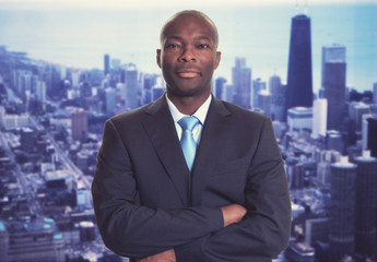 Fototapeta na wymiar Serious african american businessman with skyline