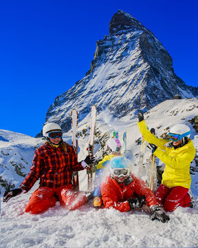 Happy family enjoying winter vacations in mountains . Ski, Sun, Snow and fun.