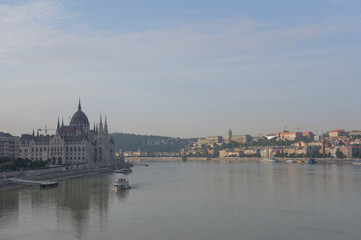 Fototapeta na wymiar Hungarian Parliament on the embankment of Danube river