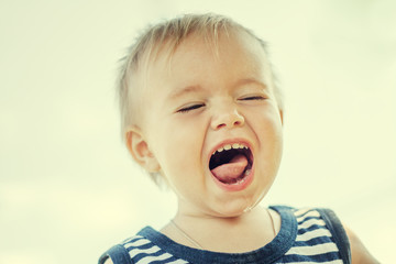 Funny little boy one year old, close-up portrait, head shot