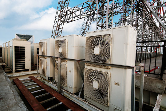 Industrial air conditioner condensers (outside unit) on the roof of a building on a hot summer day