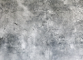 Old grey textured wall with cracks background close-up