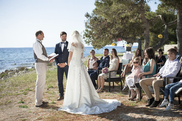 Bride and groom at wedding ceremony on beach