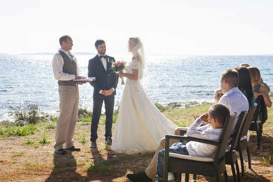 Bride and groom at wedding ceremony on beach
