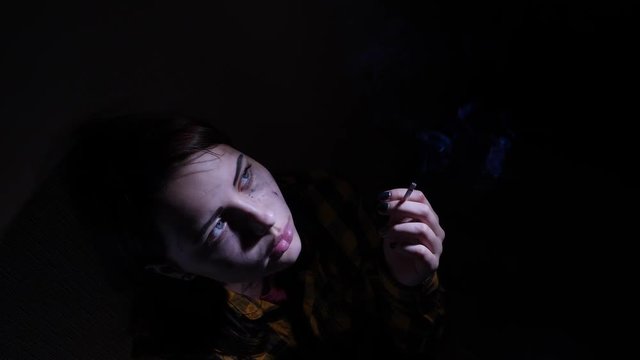 An angry sad teen girl with a cigarette