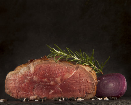 freshly grilled roast beef with rosemary and onion