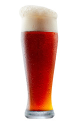 Mug of frosty dark red beer with foam isolated on a white background