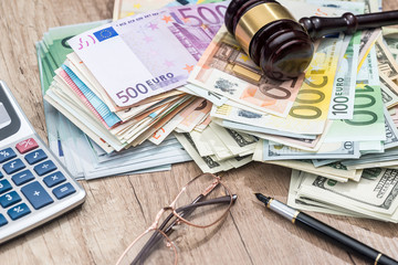 dollar,  euro, gavel, glasses, calculator and pen