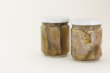 Homemade tuna jars on a white background