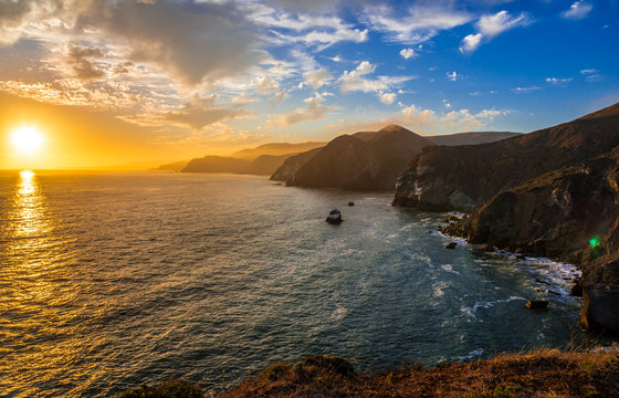 The sun sets behind the Pacific Ocean as seen from the Marin Headlands north of San Francisco, CA.