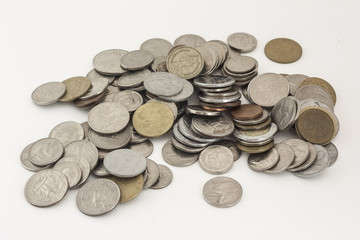 Mixed coins of various countries on a white background