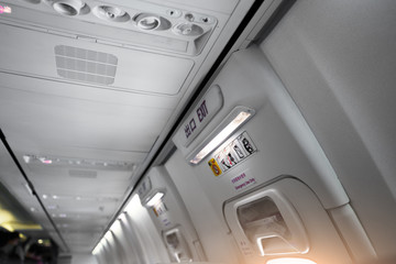 Fototapeta premium Italy, airplane cabine, emergency exit light