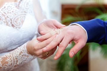 the bride wears a ring to the groom