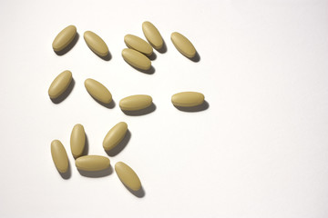 Pills of brown color on white background