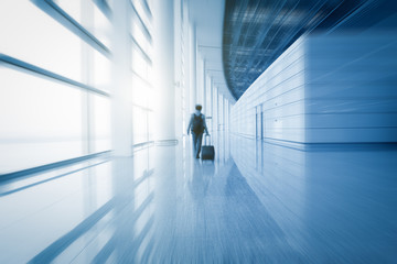 Fototapeta na wymiar modern airport scene of passenger motion blur with window outside.