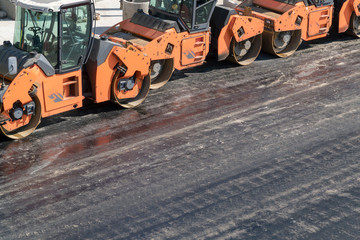 Several heavy vibration rollers at asphalt pavement works. Road repairing