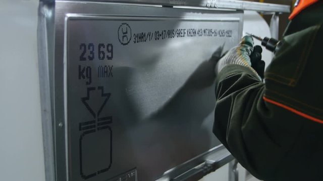 Closeup Side View Professional Worker Fixes Shining Metal Part