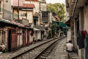 Fototapeta na wymiar Train passing through Hanoi streets and houses