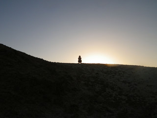 silhouette of a woman on a mountain
