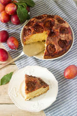 Plum pie or cake with cinnamon and sugar. Plum cake from the newspaper New York Times . Selective focus.