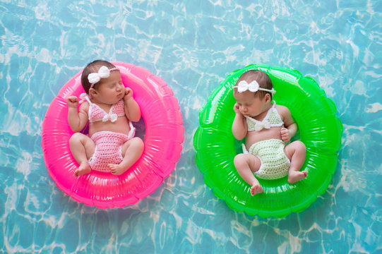 Baby Twin Girls Floating on Swim Rings