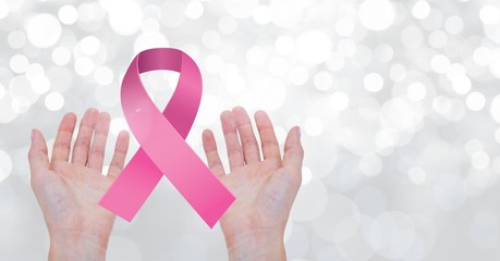 Open hands with pink ribbon for breast cancer awareness - Powered by Adobe