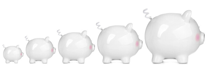 Piggy banks of different sizes on white background