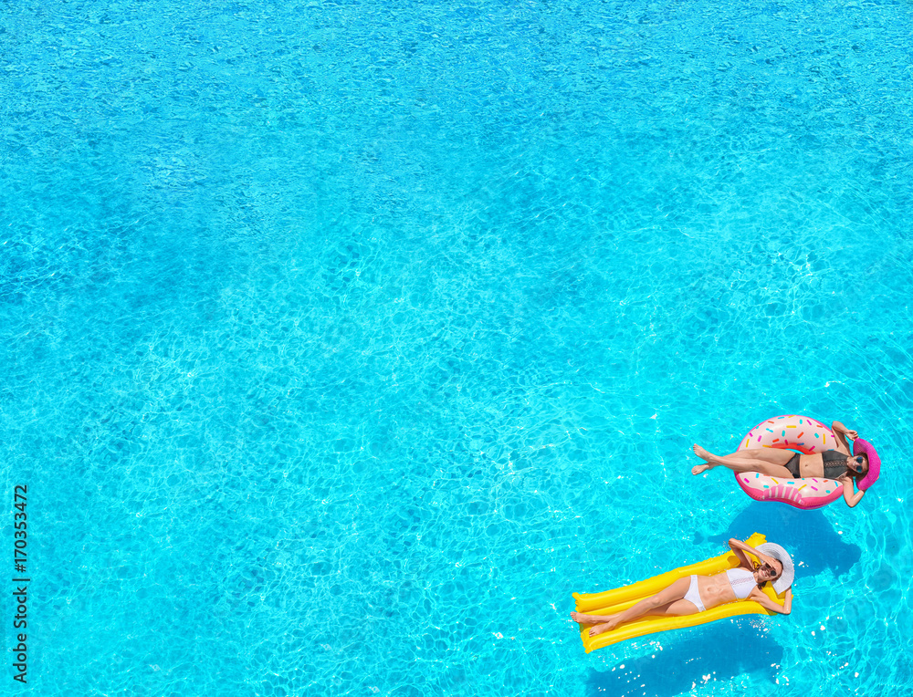 Sticker beautiful young girls with inflatable donut and mattress in blue swimming pool