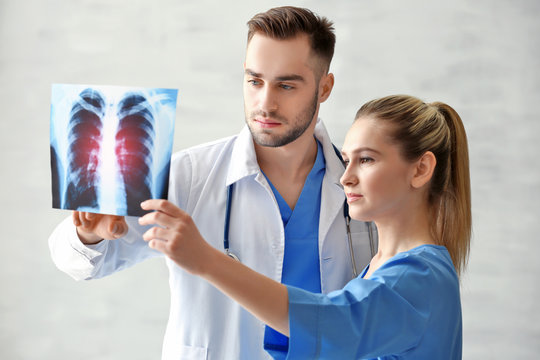 Doctor and medical assistant discussing x-ray image in office