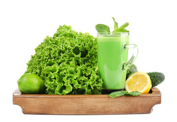Glass of green healthy juice with ingredients on white background