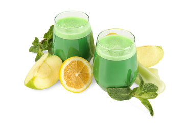 Glasses of green healthy juice with fruits on white background