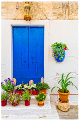 Fototapeta na wymiar Charming rustic floral decoration of streets in Greek islands