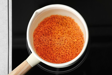 Pan with lentils on electric stove