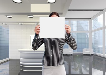 Business woman holding blank card in office