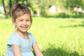 Cute little girl in park on sunny day