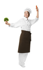 Female chef with vegetables on white background