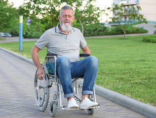 Elderly man in wheelchair outdoors