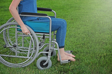 Fototapeta na wymiar Young woman in wheelchair outdoors