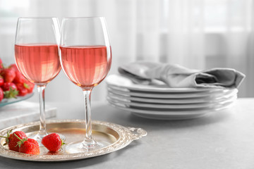Glasses of strawberry wine on golden tray